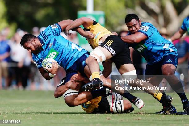 Patrick Tuipulotu of the Blues is tackled during the Super Rugby trial match between the Blues and the Hurricanes at Mahurangi Rugby Club on February...