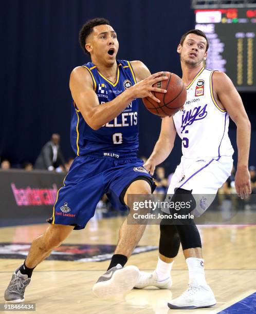 Brisbane Player Travis Trice drives past Sydney player Jason Cadee during the round 19 NBL match between the Brisbane Bullets and the Sydney Kings at...