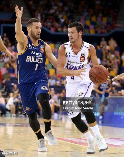 Sydney player Jason Cadee looks to drive past Brisbane Player Adam Gibson during the round 19 NBL match between the Brisbane Bullets and the Sydney...