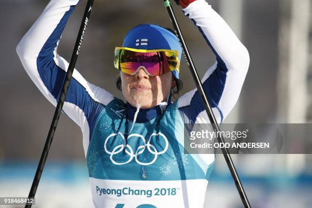 Finland's Krista Parmakoski crosses the finish line to win bronze in the women's 10km freestyle cross-country competition at the Alpensia cross...