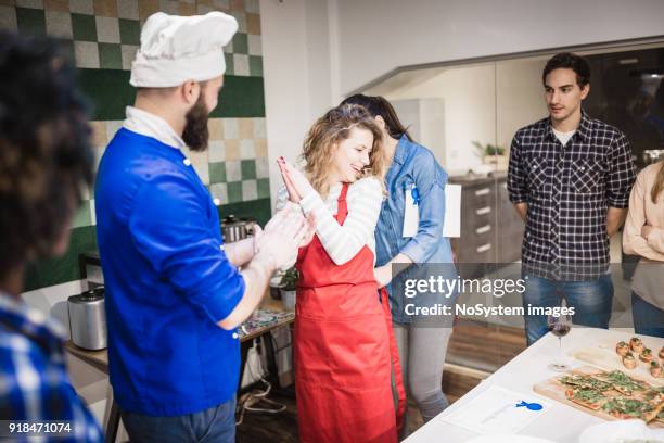 cooking class participants enjoying cooking class - awards party 2018 stock pictures, royalty-free photos & images