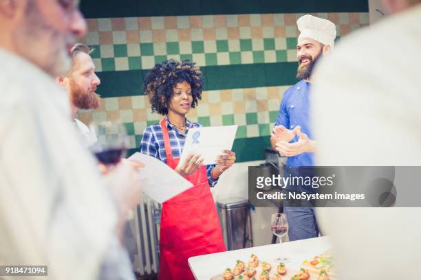 cooking class participants enjoying cooking class - awards party 2018 stock pictures, royalty-free photos & images
