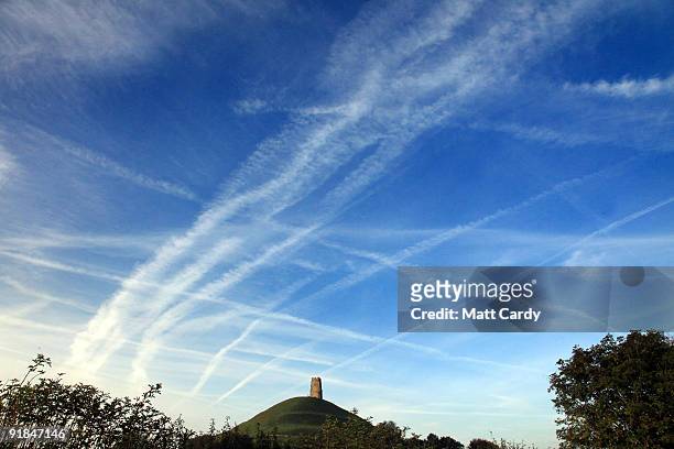 Mass of contrails left by jet aircraft are seen crossing the sky above the distinctive landmark of the historic 15th century St. Michael's Tower,...