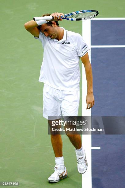Julien Benneteau of France wipes his forehead between points against Ivan Ljubicic of Croatia during their Round one match on day three of the 2009...