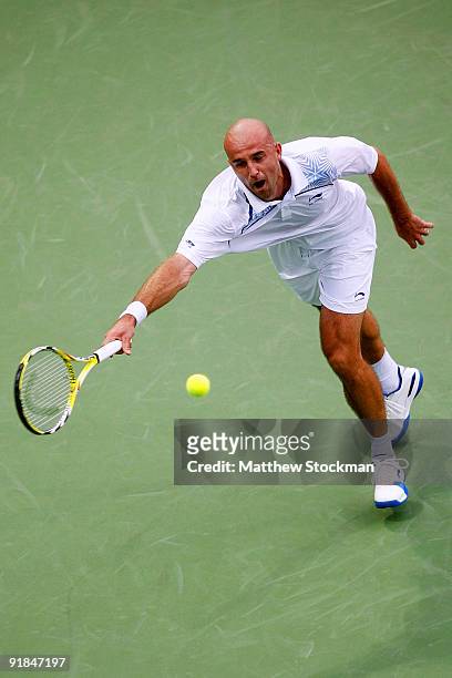 Ivan Ljubicic of Croatia lunges for a ball while playing Julien Benneteau of France during their Round one match on day three of the 2009 Shanghai...