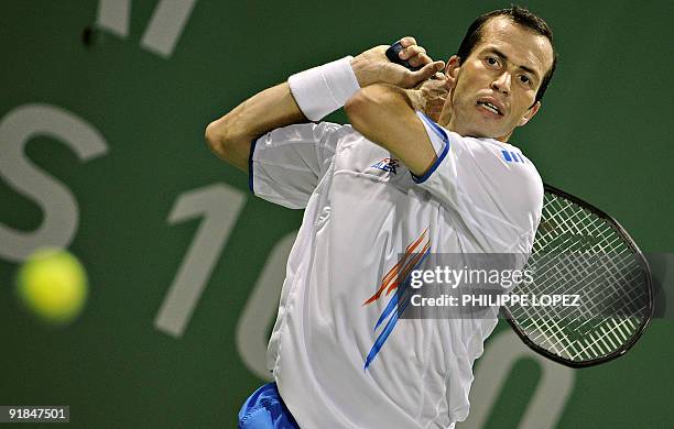 Radek Stepanek of the Czech Republic hits a return to Andreas Beck of Germany in their first round match at the ATP Shanghai Masters tennis...
