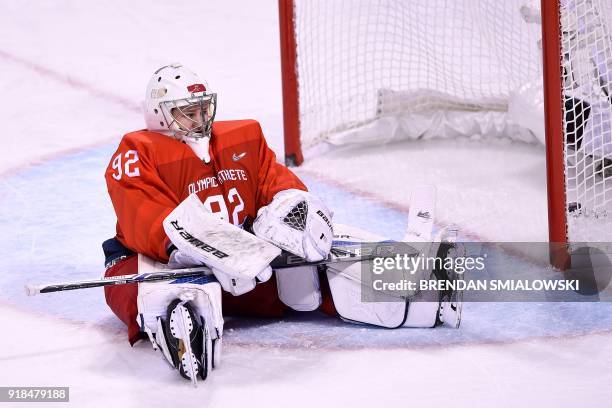 Russia's Nadezda Morozova reacts after letting in a goal in the women's preliminary round ice hockey match between Finland and Olympic Athletes from...