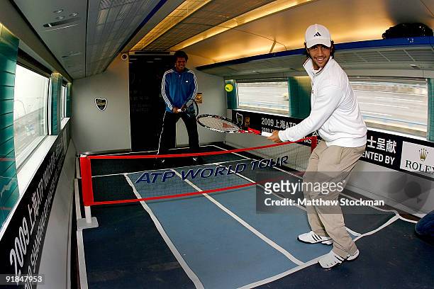 Jo-Wilfried Tsonga of France and Fernando Verdasco of Spain stage a game of tennis on 'The Fastest Tennis in the World' aboard the Maglev train of...
