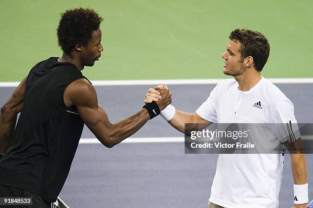 Paul-Henri Mathieu of France congratulates his compatriot Gael Monfils after loosing the match on day three of 2009 Shanghai ATP Masters 1000 at the...