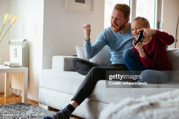 dad and daugther excited about playing video games - family time stock pictures, royalty-free photos & images