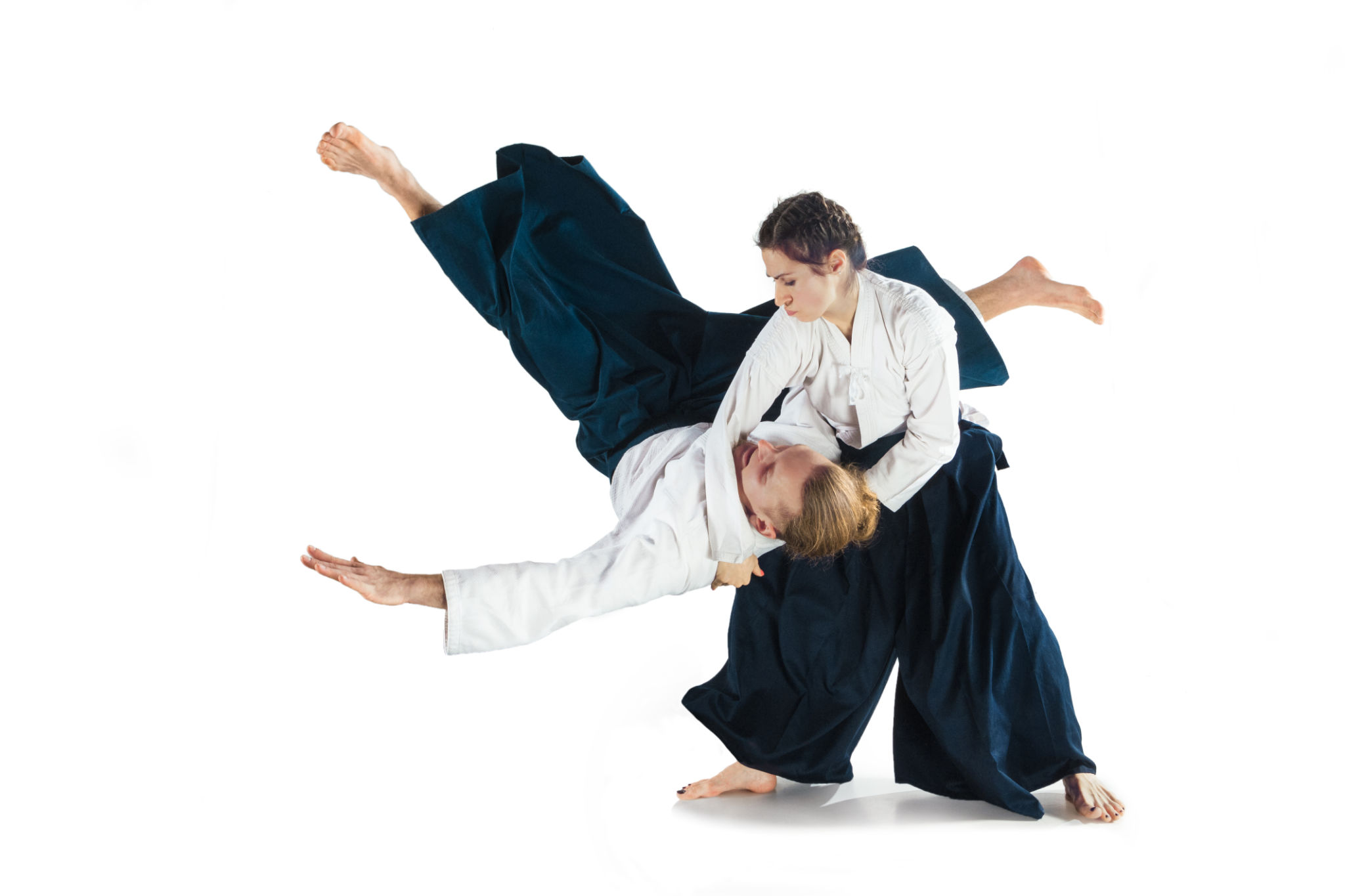 Man and woman fighting at Aikido training in martial arts school Man and woman fighting at Aikido training in martial arts school