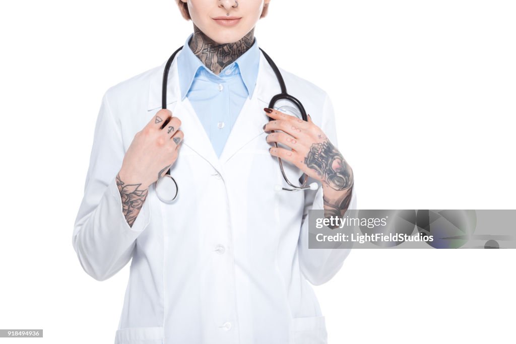 Cropped view of female doctor in white coat with stethoscope, isolated on white