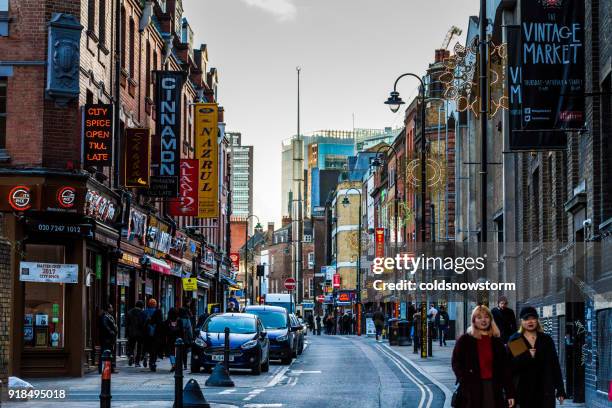 tourists walking in the crowded street of brick lane, london, uk - brick lane curry stock pictures, royalty-free photos & images