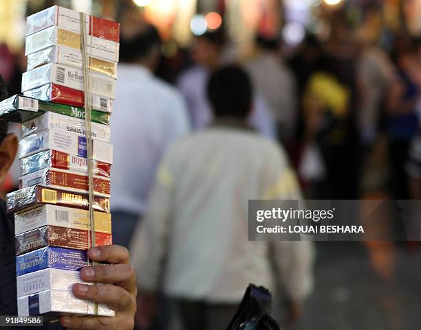 Syrian boy sells cigarettes at a market in Damascus on October 12, 2009. President Bashar al-Assad has issued a decree banning smoking in a wide...