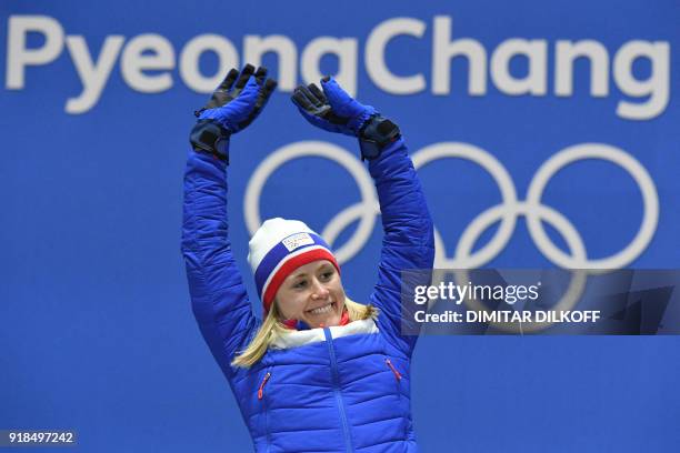 Norway's gold medallist Ragnhild Haga poses on the podium during the medal ceremony for the cross country women's 10km Free at the Pyeongchang Medals...