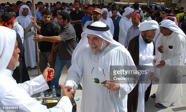Bahraini men gather to greet 19 fellow Shiites following their release from prison on October 13, 2009 in Manama, after a court in the Gulf kingdom...