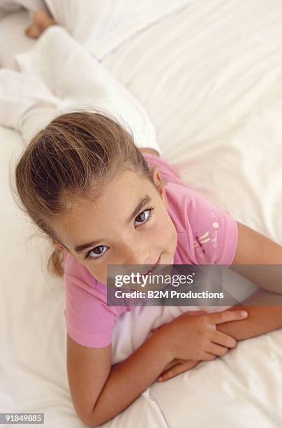 girl lying on bed looking up - enf stock pictures, royalty-free photos & images