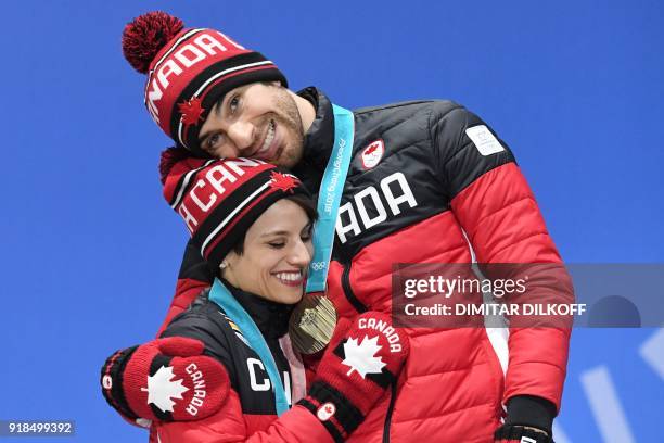 Canada's bronze medallists Meagan Duhamel and Eric Radford pose on the podium during the medal ceremony for the figure skating pair event at the...