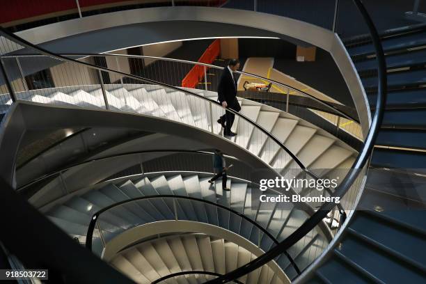 Mark Schneider, chief executive officer of Nestle SA, walks down a spiral staircase as he departs a news conference after delivering the company's...