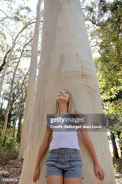 girl leaning against tree - enf stock pictures, royalty-free photos & images