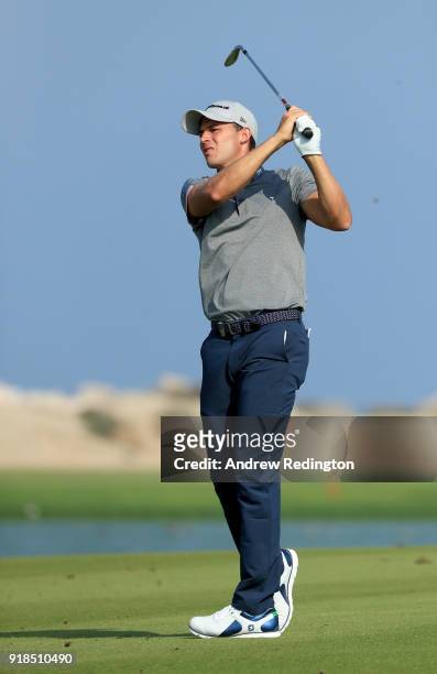 Chris Hanson of England plays his second shot on the par four 4th hole during the first round of the NBO Oman Open at Al Mouj Golf on February 15,...
