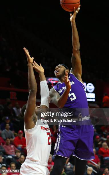 Dererk Pardon of the Northwestern Wildcats attempts a shot as Mamadou Doucoure defends during the second half of a game at Rutgers Athletic Center on...
