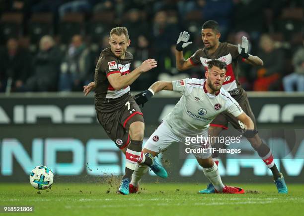 Bernd Nehrig of St. Pauli and Eduard Loewen of Nuernberg and Jeremy Dudziak of St. Pauli battle for the ball during the Second Bundesliga match...