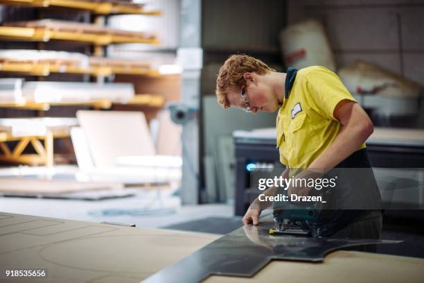 candid portrait of engineer working in factory - probation stock pictures, royalty-free photos & images