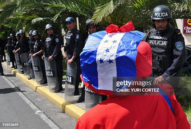 Woman supporter of deposed Honduran President Manuel Zelaya takes part in a protest rally in front of the hotel where the talks take place, on...