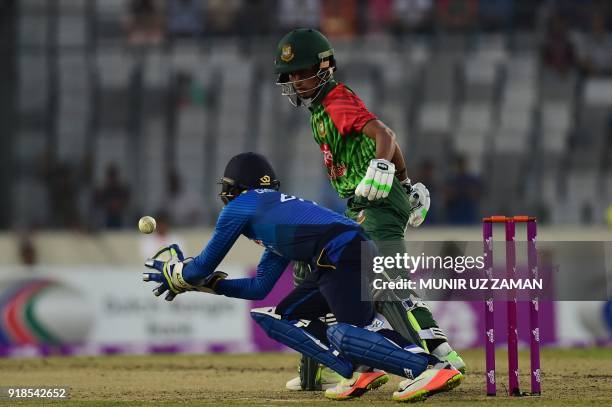 Sri Lanka cricketer Niroshan Dickwella takes a catch successfully to dismiss Bangladesh cricketer Afif Hossain during the first Twenty20 cricket...