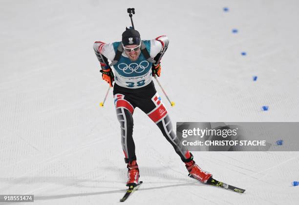 Austria's Dominik Landertinger crosses the finish line in the men's 20km individual biathlon event during the Pyeongchang 2018 Winter Olympic Games...