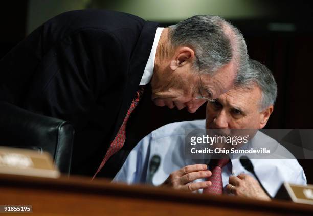 Senate Finance Committee ranking member Sen. Charles Grassley talks with Sen. Jon Kyl during a committee hearing about key health care reform...