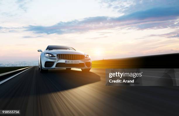 car driving on a road by sea - auto 3d imagens e fotografias de stock