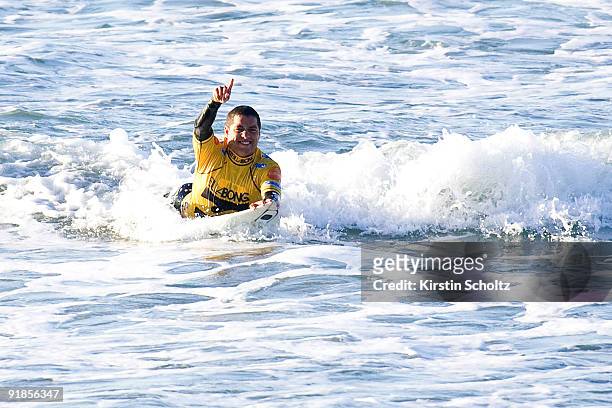 Adriano De Souza of Brazil claims his victory as he exits the surf at the Billabong Pro Mundaka in the Basque Region on October 13, 2009 in Mundaka,...