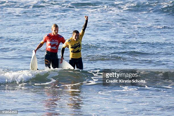 Adriano De Souza of Brazil is congratulated by Chris Davidson of Australia after winning the Billabong Pro Mundaka in the Basque Region on October...