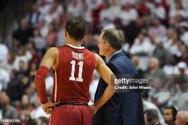 Trae Young of the Oklahoma Sooners and head coach Lon Kruger of the Oklahoma Sooners stand on the court during the game against the Texas Tech Red...