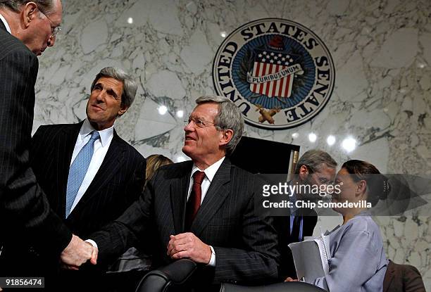 Senate Finance Committee Chairman Max Baucus is congratulated by Sen. John Rockefeller and Sen. John Kerry after the committee passed health care...