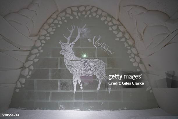 A sculpted reindeer on a wall of the Snow Castle. Pure white snow walls surround the gigantic SnowCastle built entirely out of snow and ice, both...