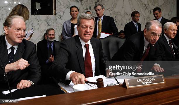 Senate Finance Committee Chairman Max Baucus lowers the gavel after the committee voted 14-9 to pass health care reform legislation with Sen. John...