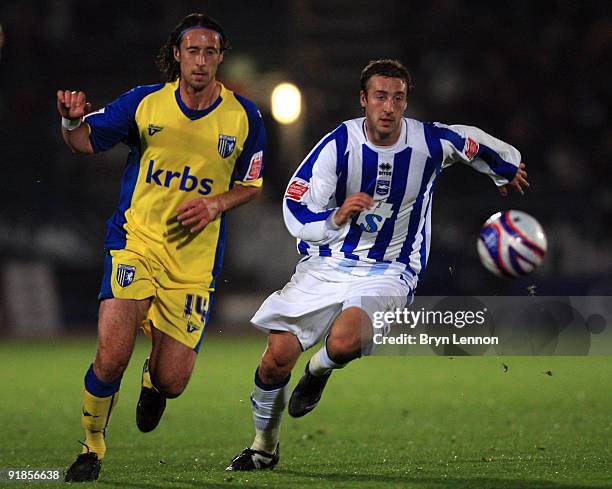 Glenn Murray of Brighton and Hove Albion avoids Adam Miller of Gillingham during the Coca-Cola League One match between Brighton & Hove Albion and...