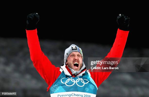 Bronze medallist Dominik Landertinger of Austria celebrates during the victory ceremony for the Men's 20km Individual Biathlon at Alpensia Biathlon...