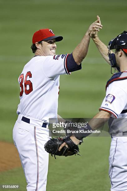 Joe Nathan of the Minnesota Twins celebrates the win over the Kansas City Royals with catcher Joe Mauer on October 3, 2009 at the Metrodome in...