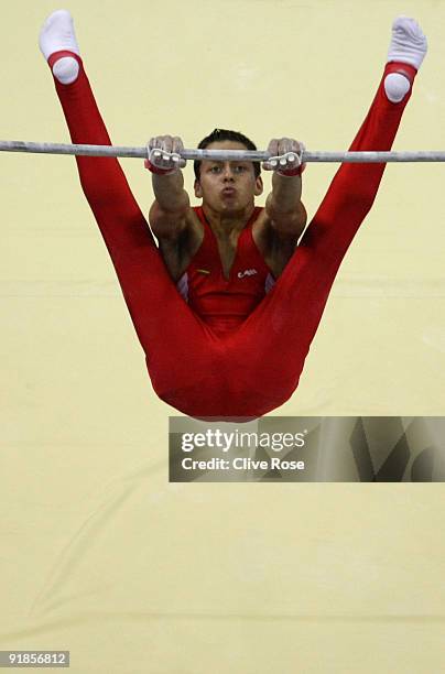 Jevgenij Izmodenov of Lithuania competes on the horizontal bar during the Artistic Gymnastics World Championships 2009 at O2 Arena on October 13,...