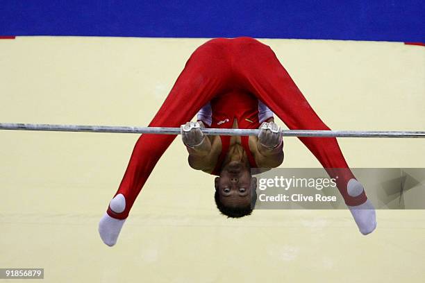 Jevgenij Izmodenov of Lithuania competes on the horizontal bar during the Artistic Gymnastics World Championships 2009 at O2 Arena on October 13,...