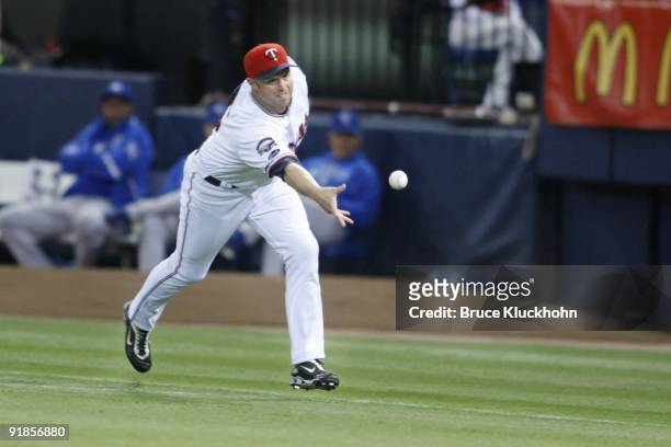 Michael Cuddyer of the Minnesota Twins tosses the ball to put out a member of the Kansas City Royals who hit it to him on October 3, 2009 at the...
