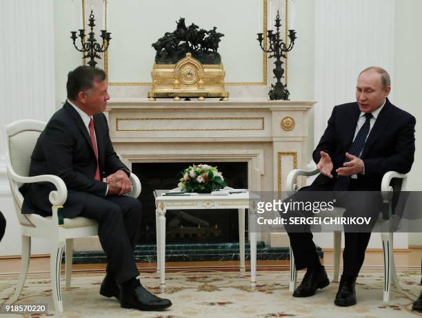 Russian President Vladimir Putin speaks with King Abdullah II of Jordan during their meeting at the Kremlin in Moscow, on February 15, 2018. / AFP...