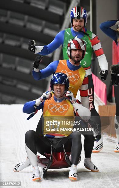 Matthew Mortensen , Jayson Terdiman and Chris Mazdzer celebrate after competing in the team relay competition luge final during the Pyeongchang 2018...