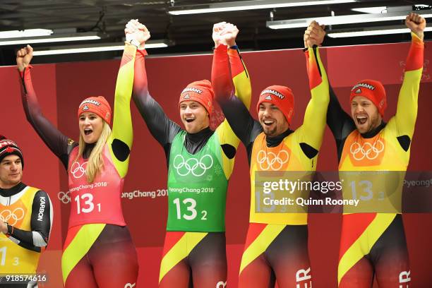 Gold medalists Natalie Geisenberger, Johannes Ludwig, Tobias Wendl and Tobias Arlt of Germany celebrate on the podium during the victory ceremony...