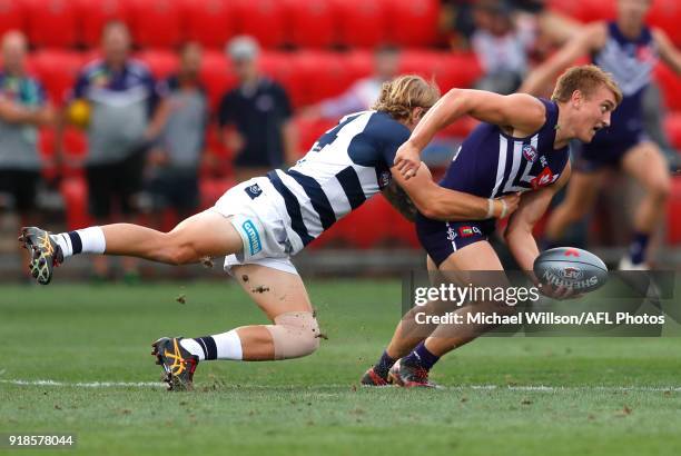 Mitchell Crowden of the Dockers is tackled by Tom Stewart of the Cats during the AFLX match between the Geelong Cats and the Fremantle Dockers at...
