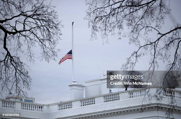 The American flag above the White House is lowered to half staff following the shooting yesterday at Marjory Stoneman Douglas High School on February...